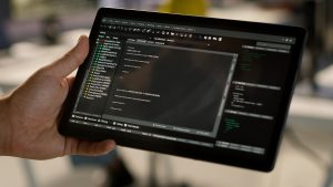 Close up of admin in office sing tablet to design machine learning algorithms