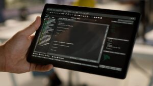 Close up of admin in office sing tablet to design machine learning algorithms